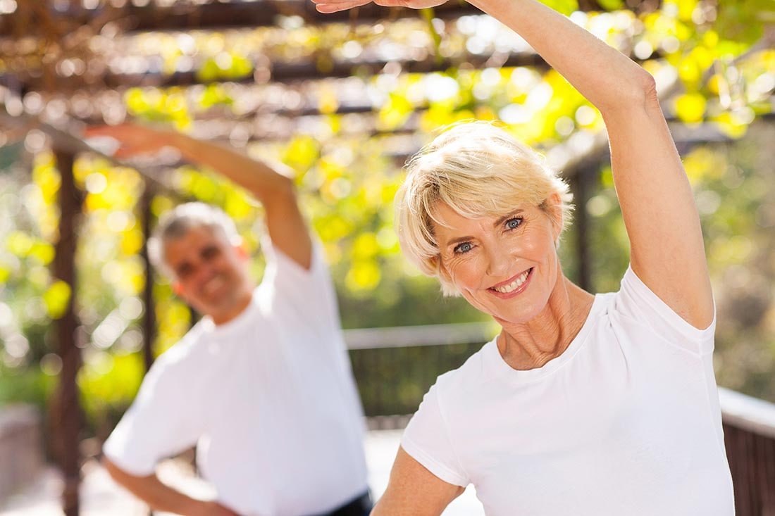 Woman pacticing yoga with husband