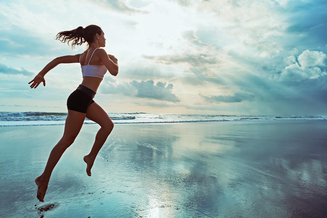 Young woman running on beach