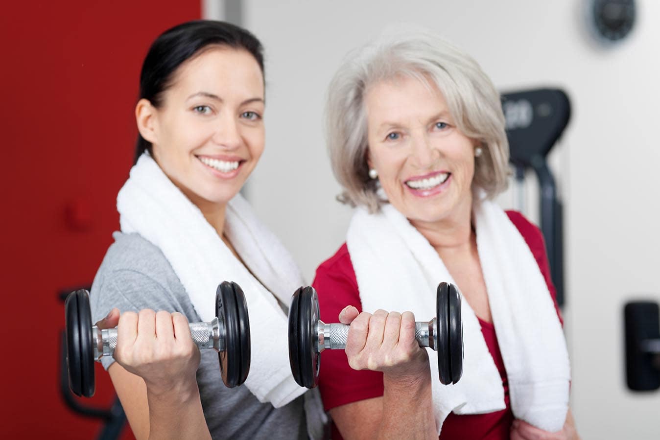 Growned and young woman lifting hand weights